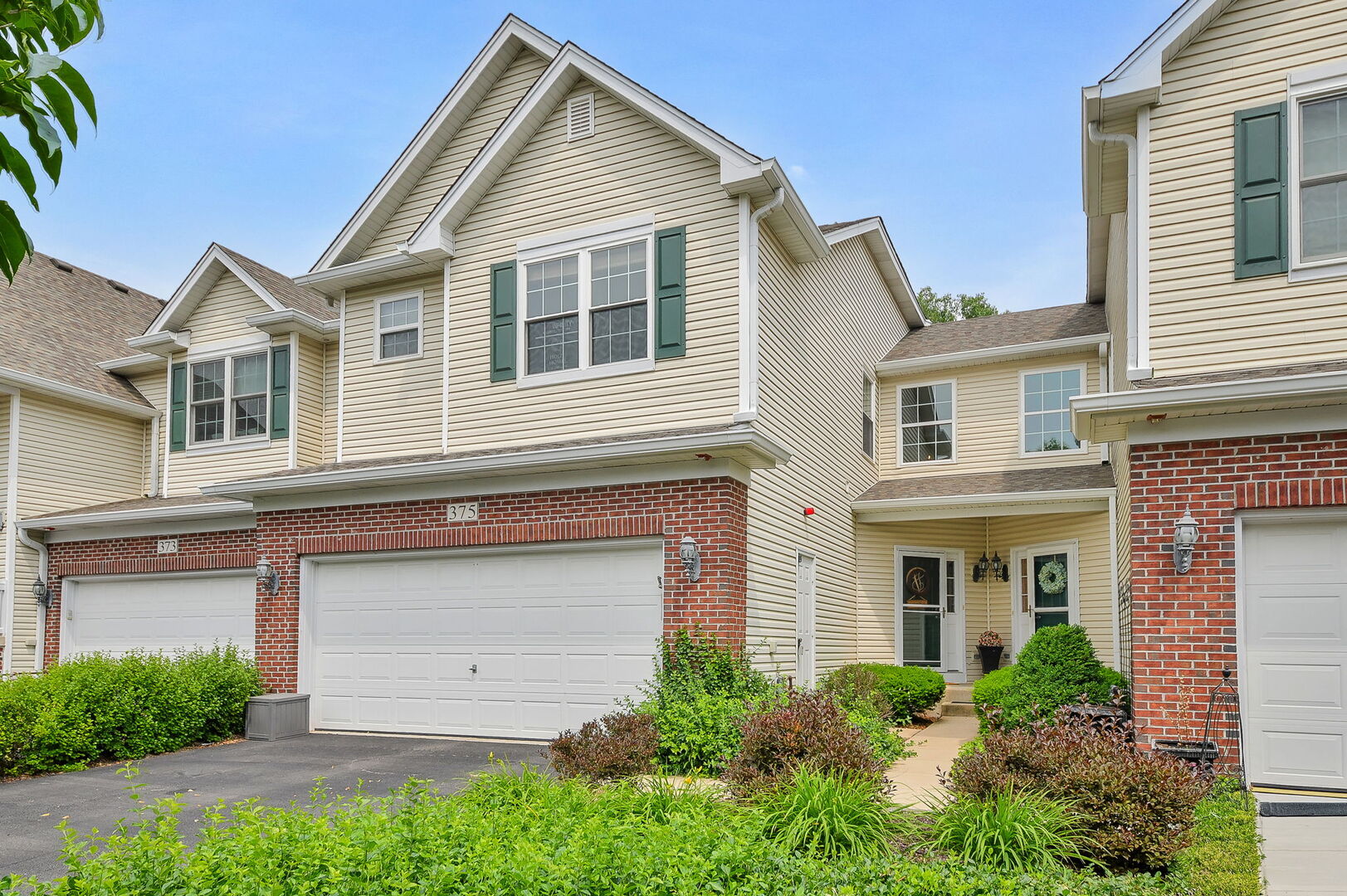 375 Ridge Road North Aurora, IL 60542 - Photo 24 of 24 a front view of a house with a garden and garage