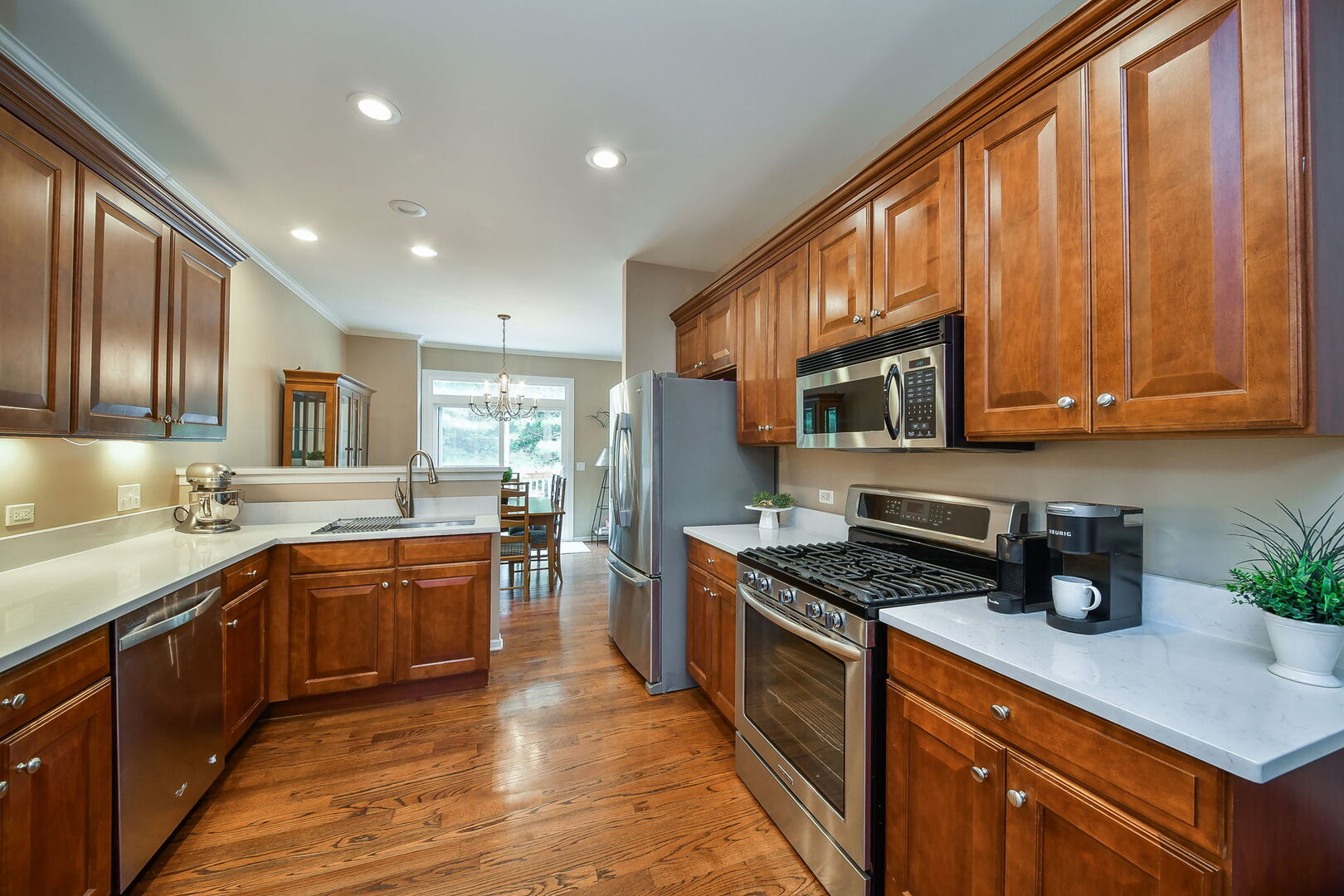 375 Ridge Road North Aurora, IL 60542 - Photo 8 of 24 a kitchen with stainless steel appliances granite countertop wooden cabinets a sink dishwasher a stove and a refrigerator