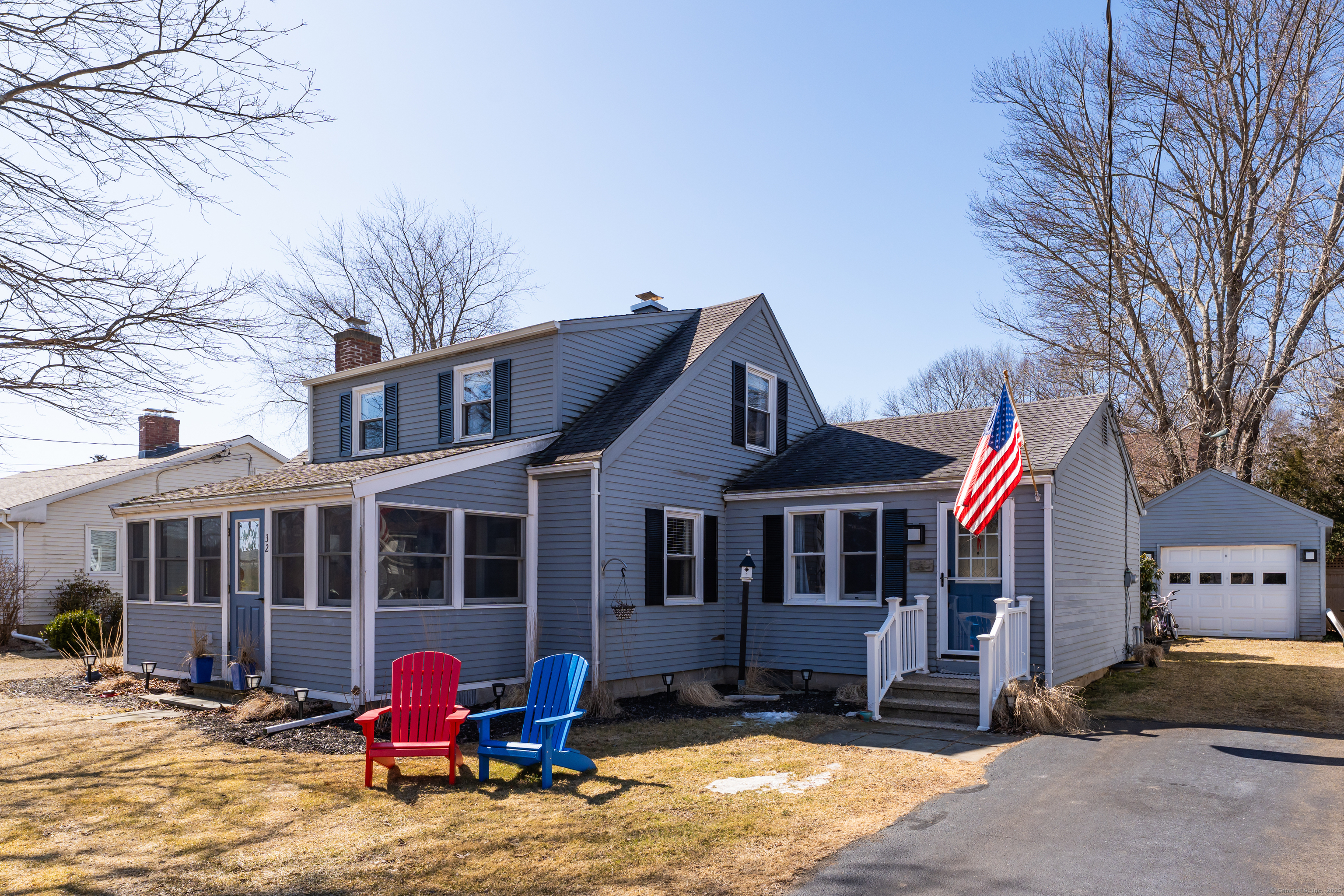 32 Bassett Lane Madison, CT 06443 - Photo 2 of 39 a front view of a house with yard and seating area