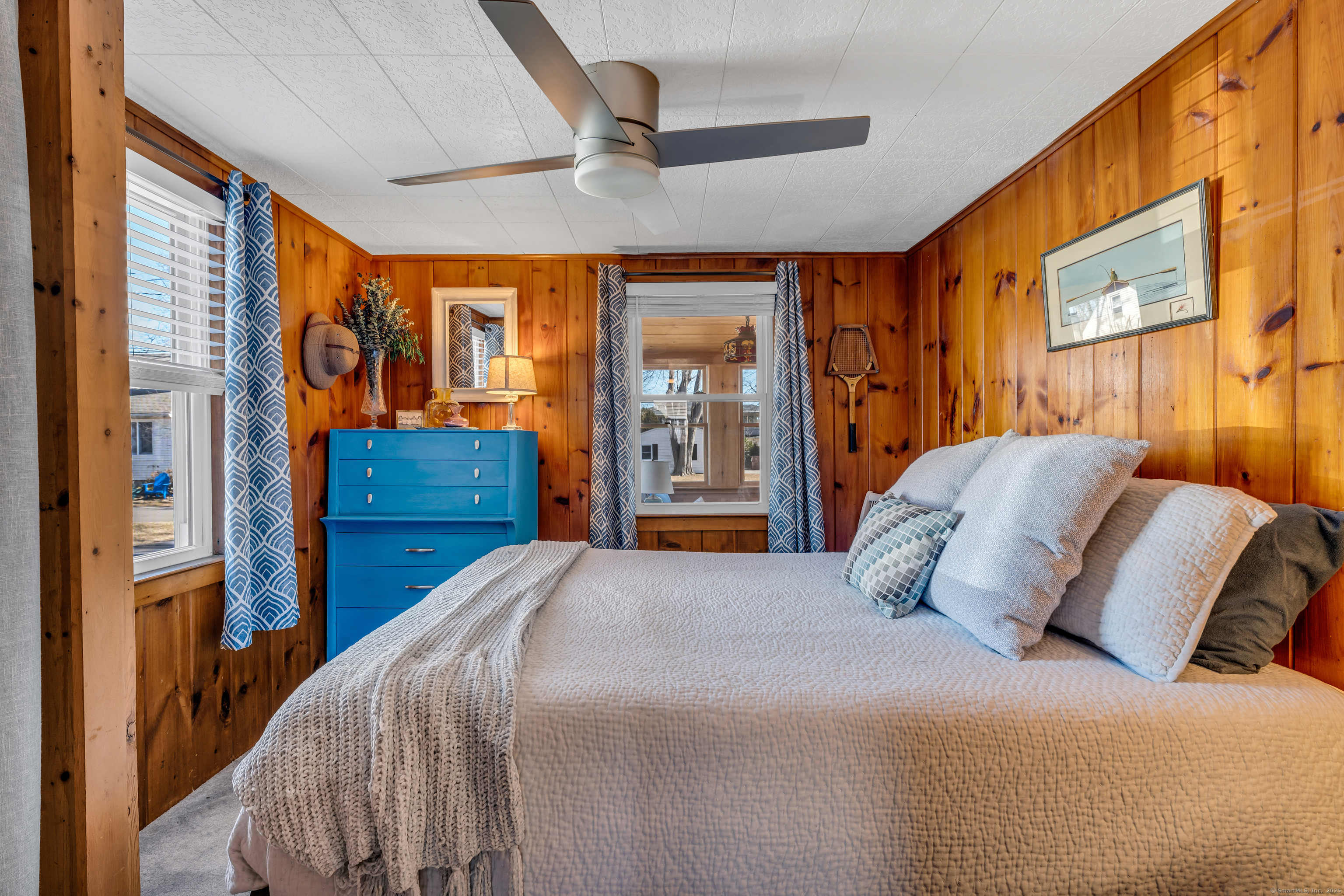 32 Bassett Lane Madison, CT 06443 - Photo 25 of 39 a bedroom with a large bed and a large window with the outer view