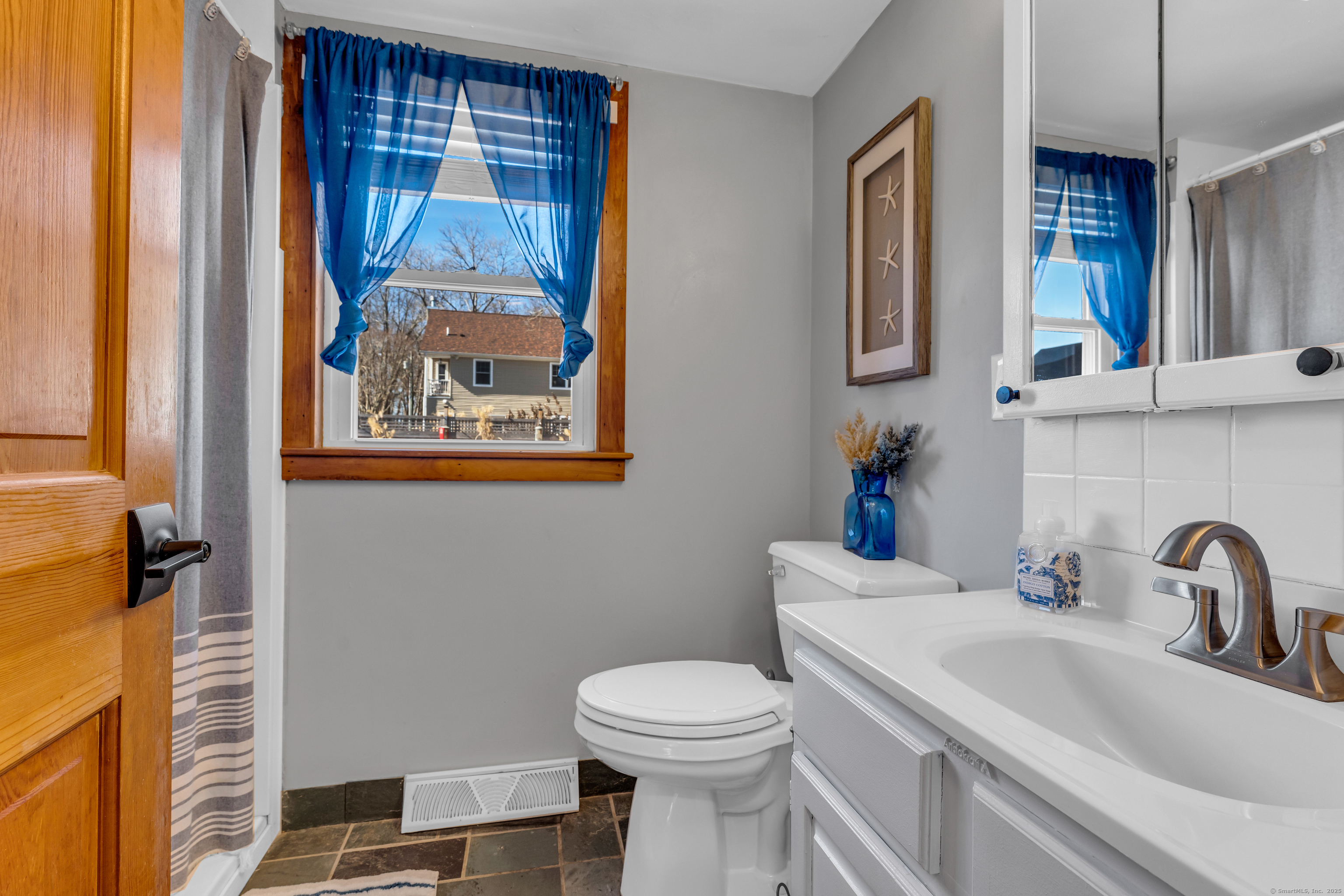 32 Bassett Lane Madison, CT 06443 - Photo 26 of 39 a bathroom with a sink and a toilet