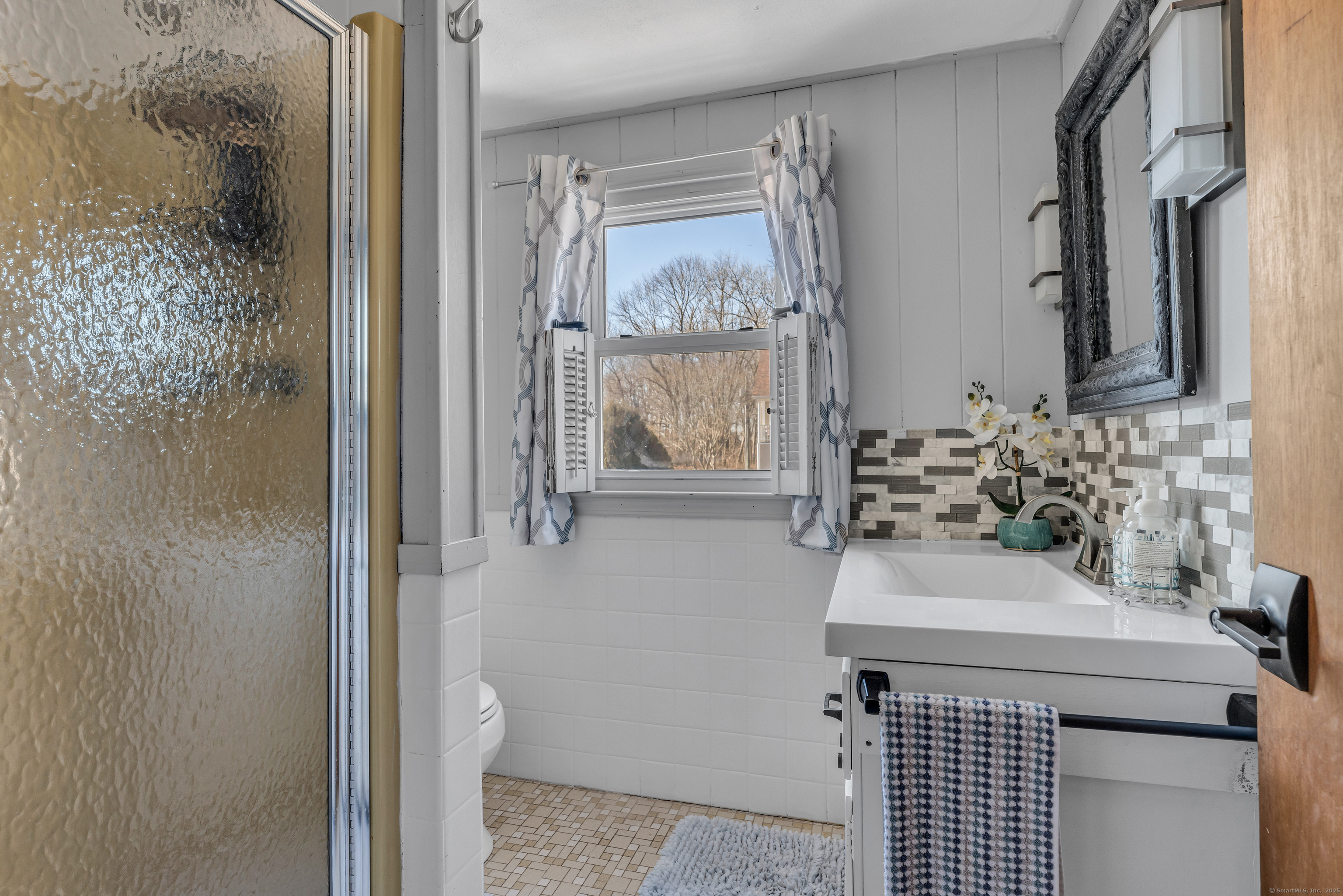 32 Bassett Lane Madison, CT 06443 - Photo 33 of 39 a bathroom with a sink a toilet and shower