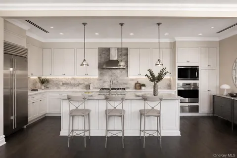 a kitchen with stainless steel appliances kitchen island granite countertop a stove a sink and a refrigerator