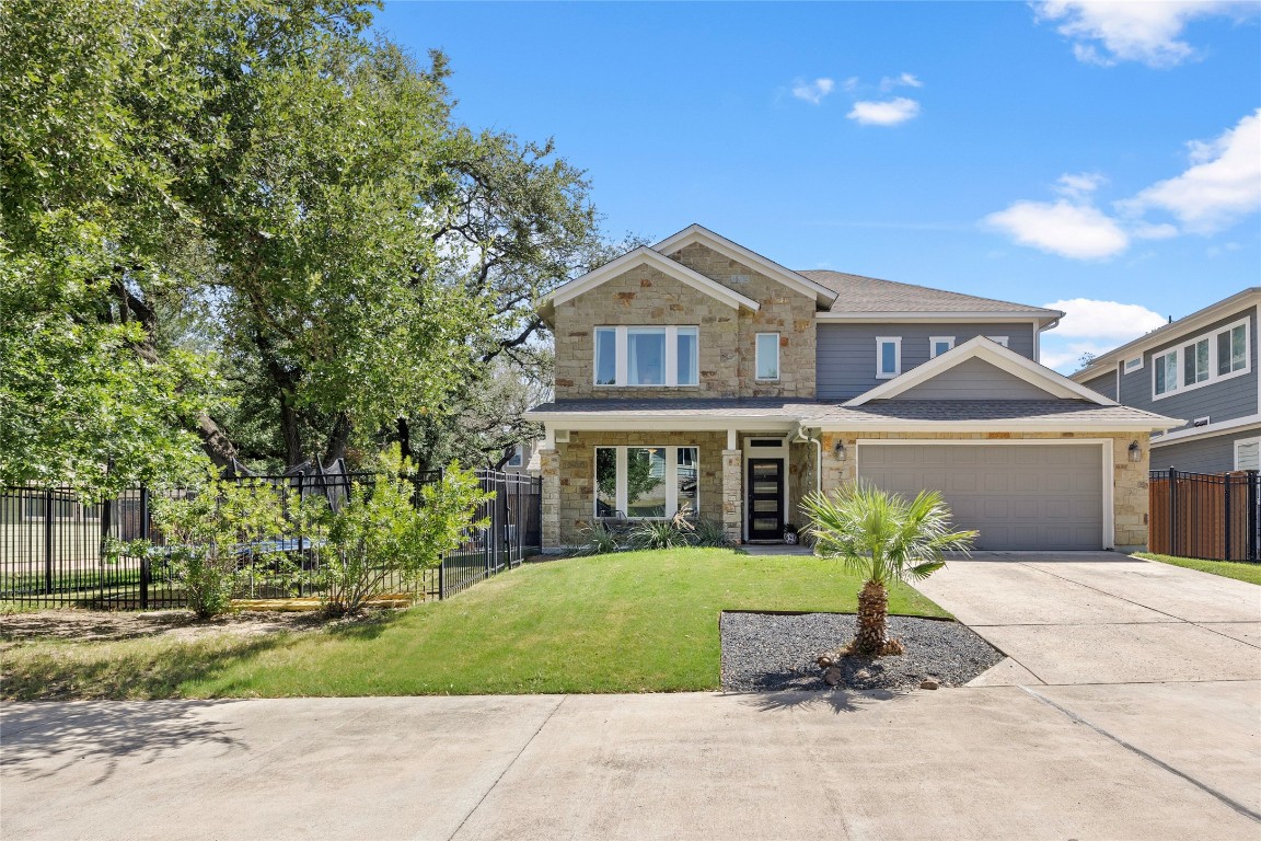 a front view of a house with a garden and plants
