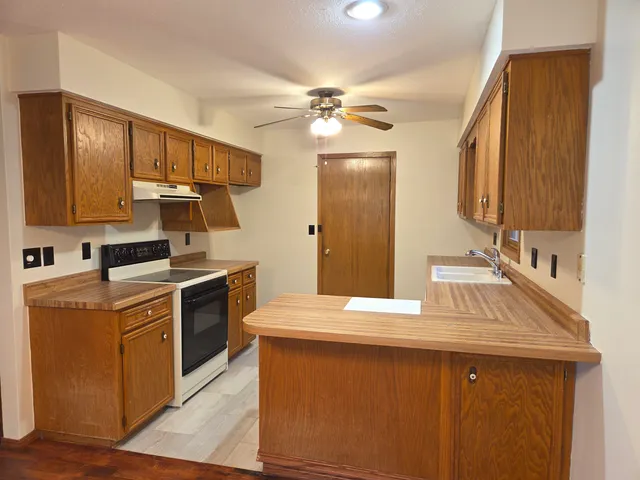 a kitchen with a sink appliances and cabinets