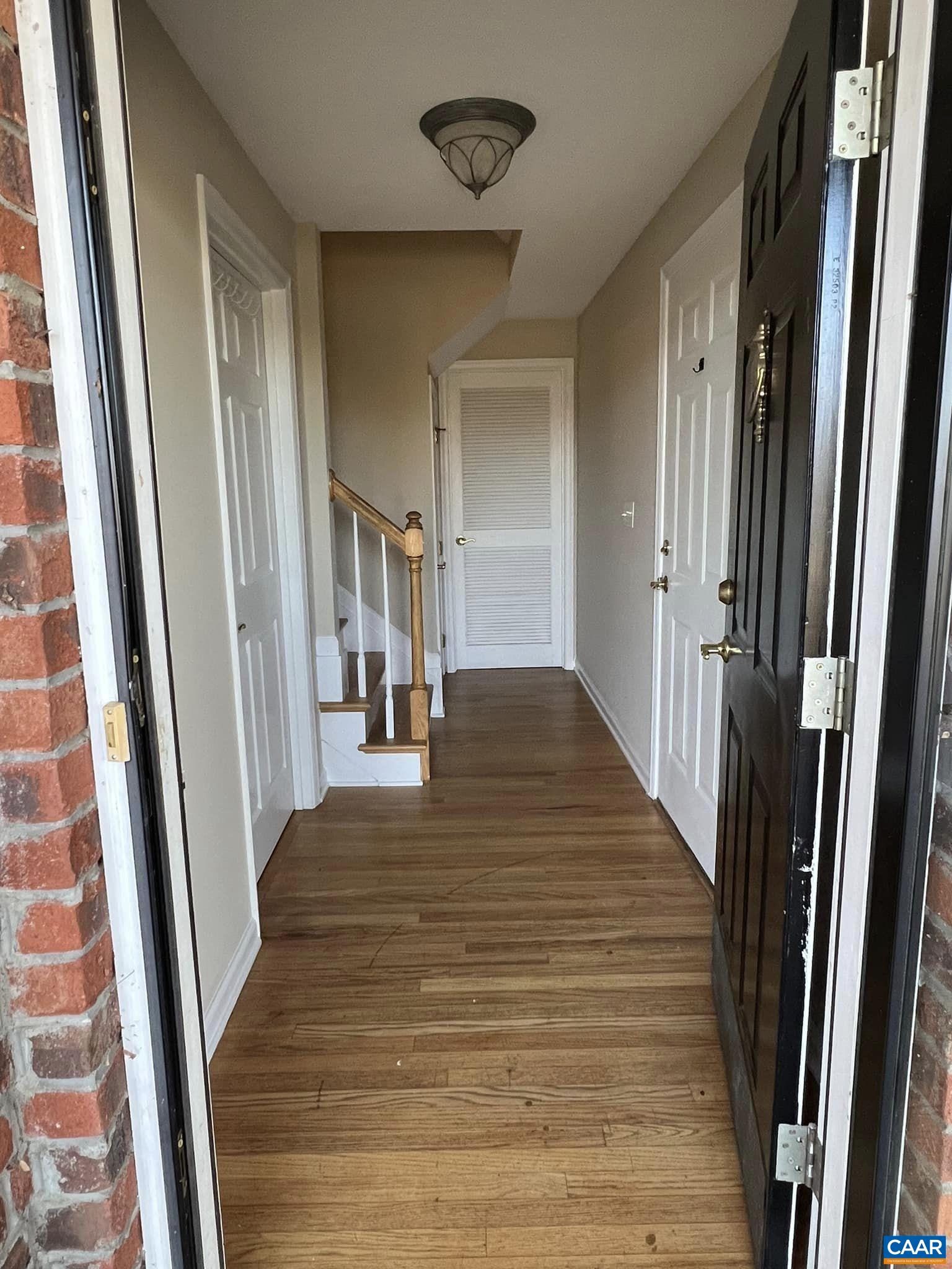 131 Burnet Street Charlottesville, VA 22902 - Photo 2 of 26 a view of a hallway with wooden floor and staircase