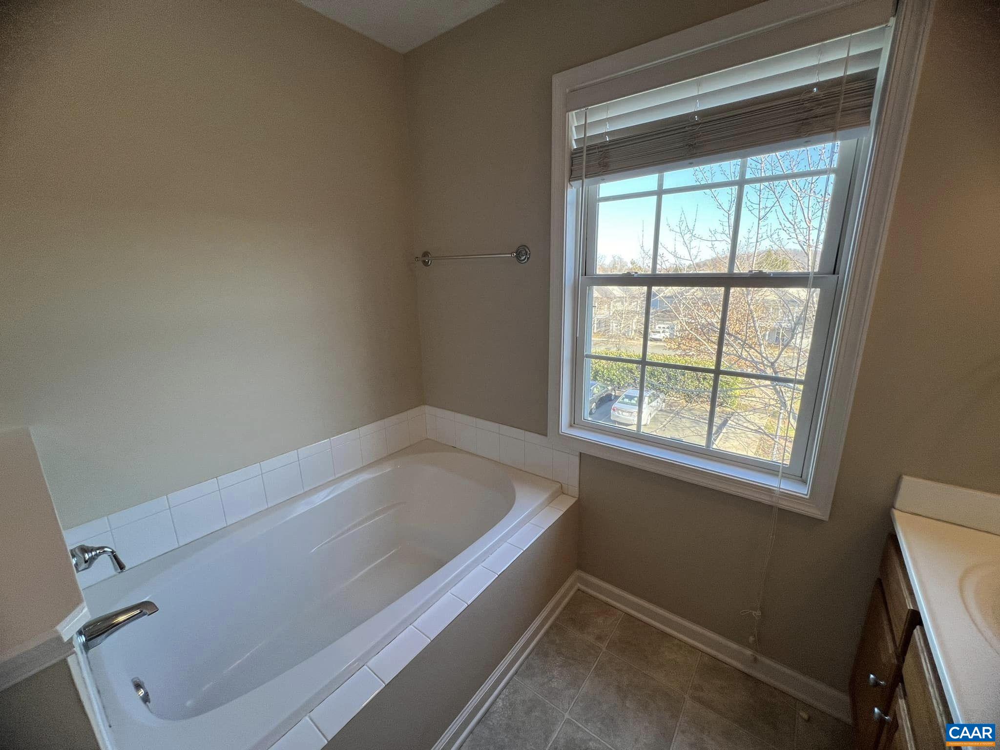 131 Burnet Street Charlottesville, VA 22902 - Photo 21 of 26 a bath tub sitting in a bathroom next to a window