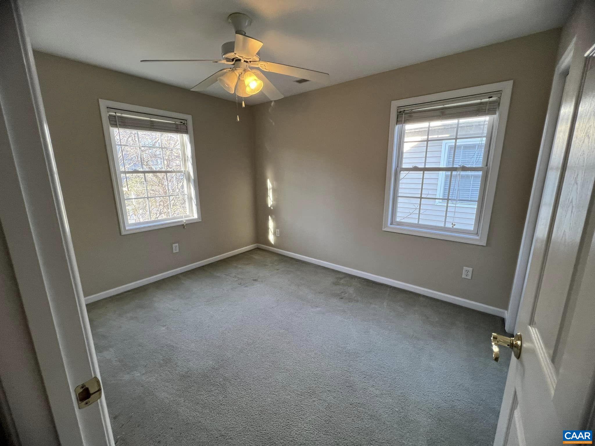 131 Burnet Street Charlottesville, VA 22902 - Photo 24 of 26 an empty room with windows and chandelier fan
