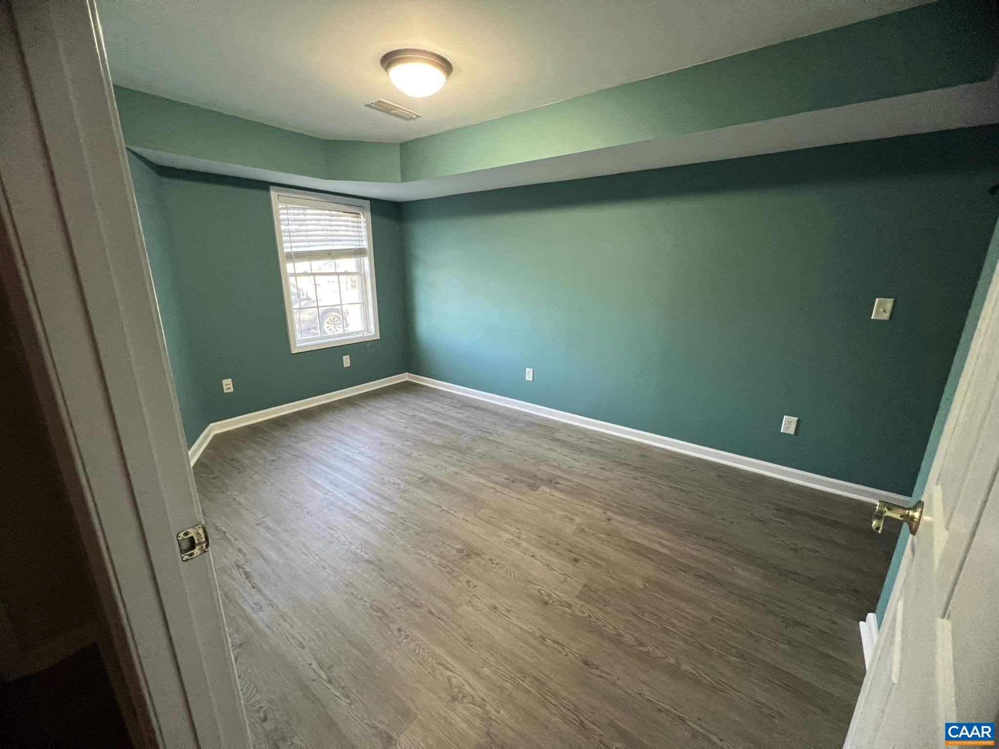 131 Burnet Street Charlottesville, VA 22902 - Photo 4 of 26 an empty room with wooden floor and windows