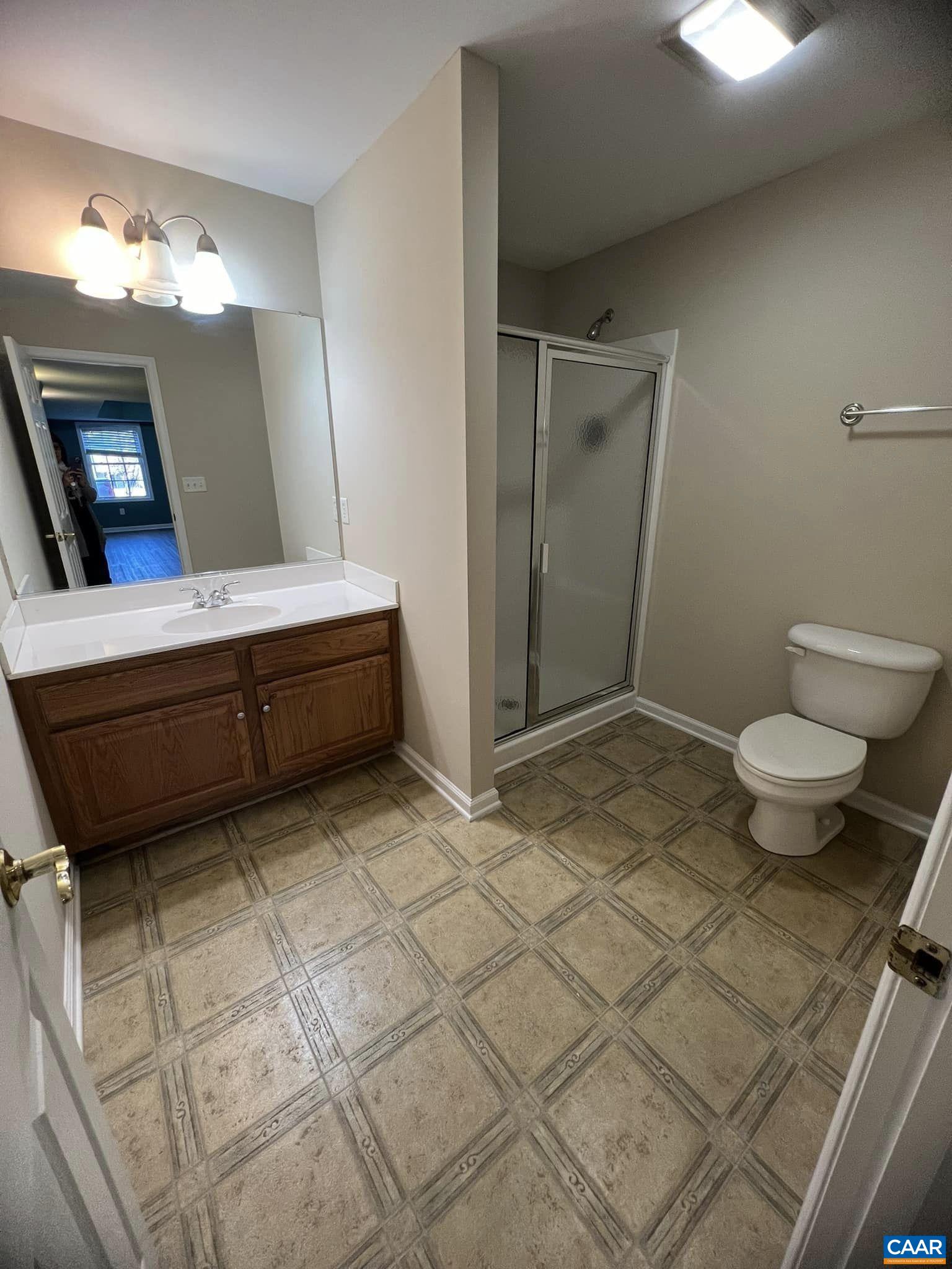 131 Burnet Street Charlottesville, VA 22902 - Photo 5 of 26 a bathroom with a sink a toilet and mirror