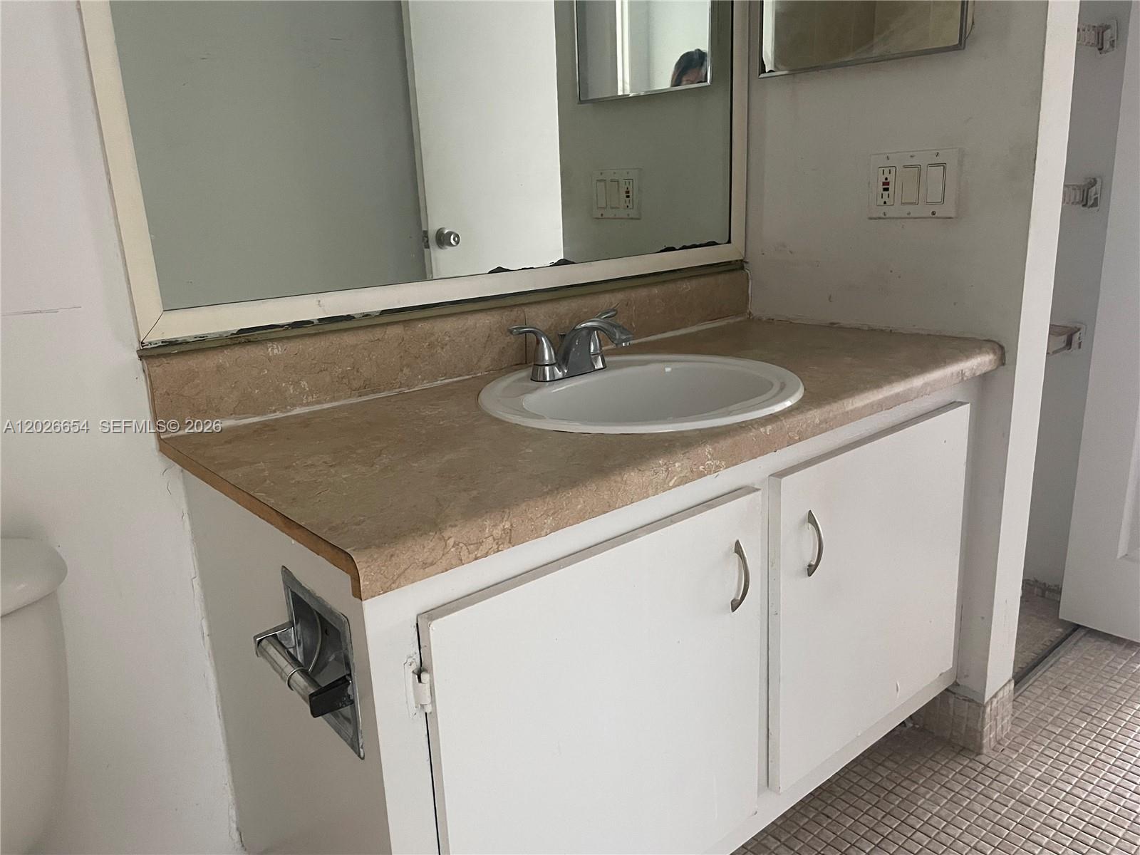 4174 Inverrary Drive, Unit 903 Lauderhill, FL 33319 - Photo 16 of 36 a bathroom with a sink and a mirror