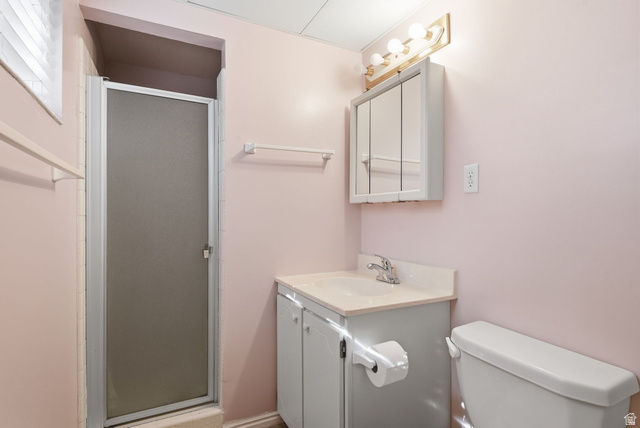 2524 Camelback Road Cottonwood Heights, UT 84121 - Photo 39 of 49 Enclosed shower with frosted glass, vanity with integrated sink, wall-mounted medicine cabinet, and overhead light fixture