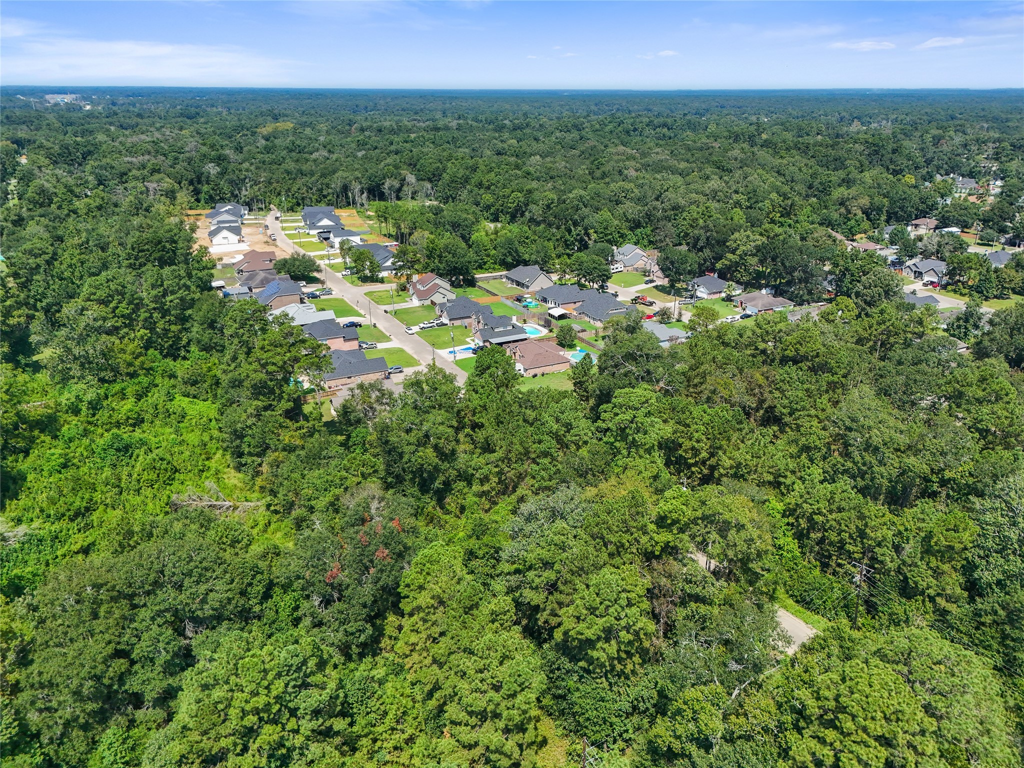 Tbd Tbd Lane Splendora, TX 77372 - Photo 4 of 10 a view of a city with lush green forest