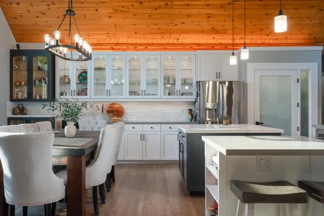 a kitchen with a table chairs sink and cabinets