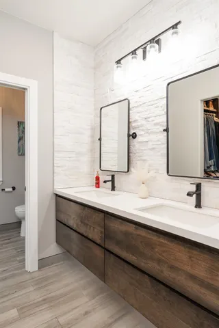 a bathroom with a double vanity sink and mirror