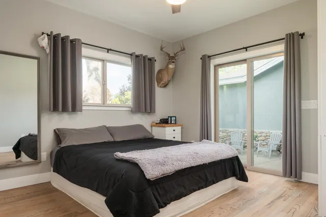 a bedroom with a large bed and a window