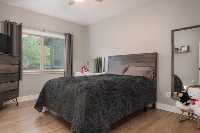 a bedroom with a bed and a window