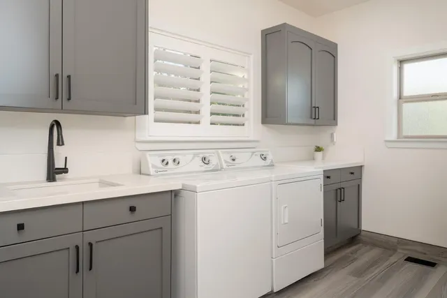 a kitchen with sink cabinets and appliances