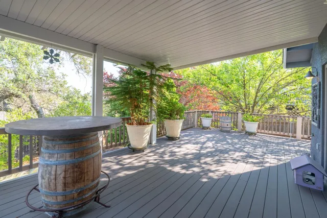 a view of a porch with furniture and garden