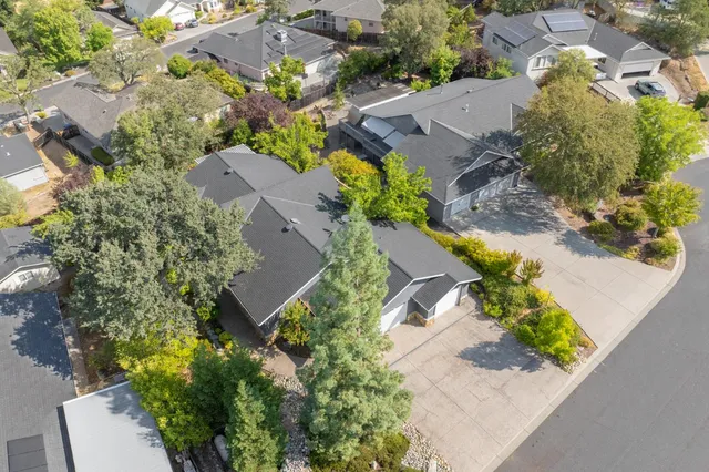 an aerial view of a house with a yard