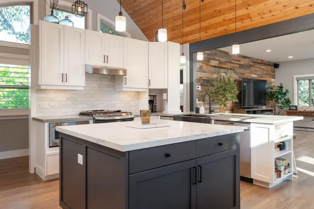 a kitchen with a sink stove and cabinets