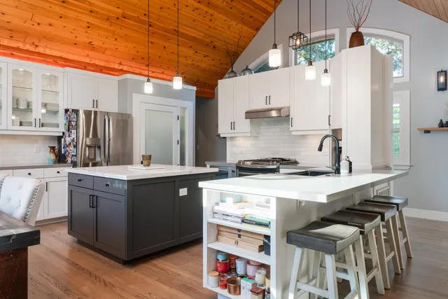 a kitchen with stainless steel appliances a stove a sink dishwasher and a refrigerator