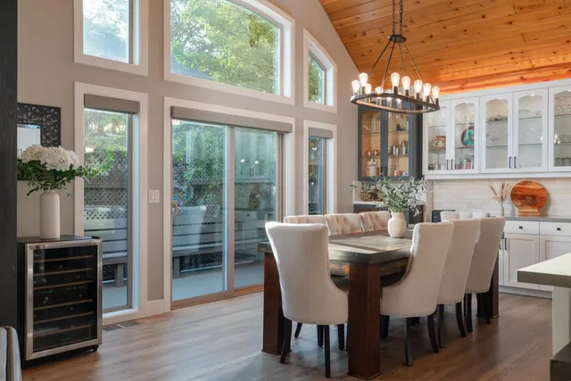 a view of a dining room with furniture a chandelier and wooden floor