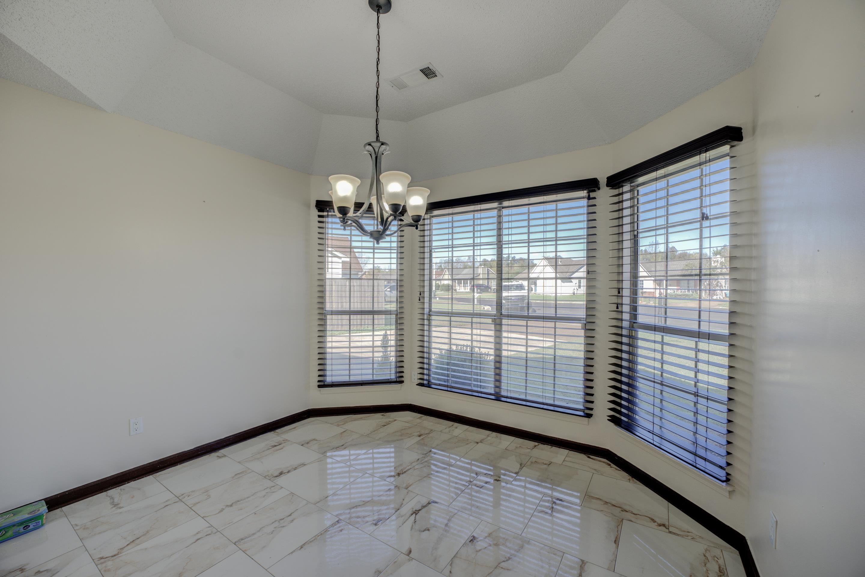 6735 Elmore Ridge Cove Memphis, TN 38134 - Photo 7 of 30 Unfurnished dining area with a notable chandelier