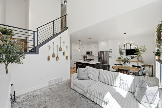 57 McCall Ln. Farmington, UT 84025 - Photo 14 of 36 Open-concept living space with high ceilings and a modern iron stair railing