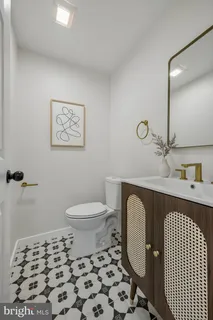 a bathroom with a toilet a sink and a mirror
