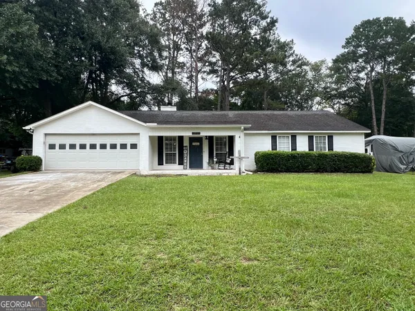 a front view of a house with a garden