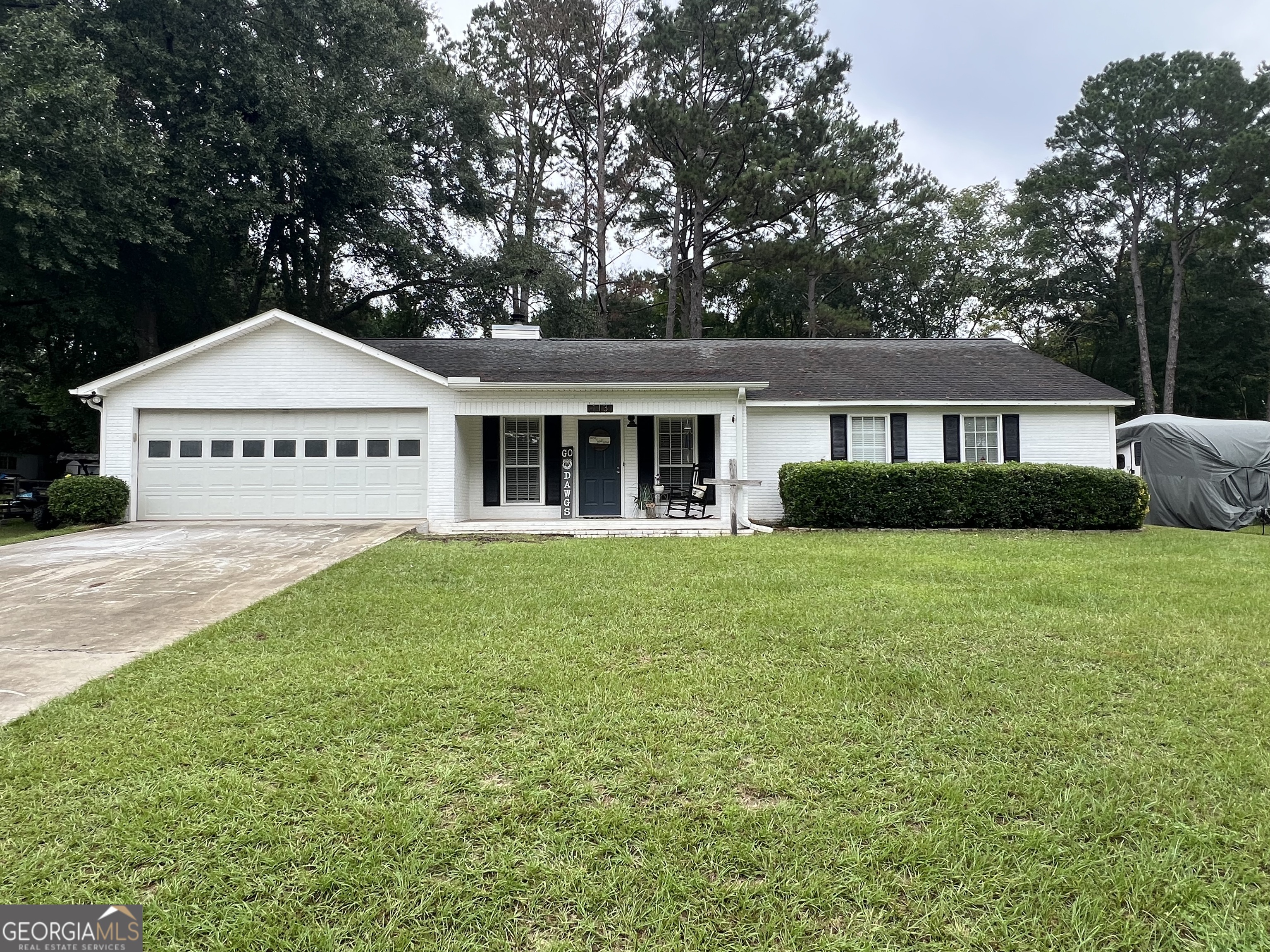 a front view of a house with a garden
