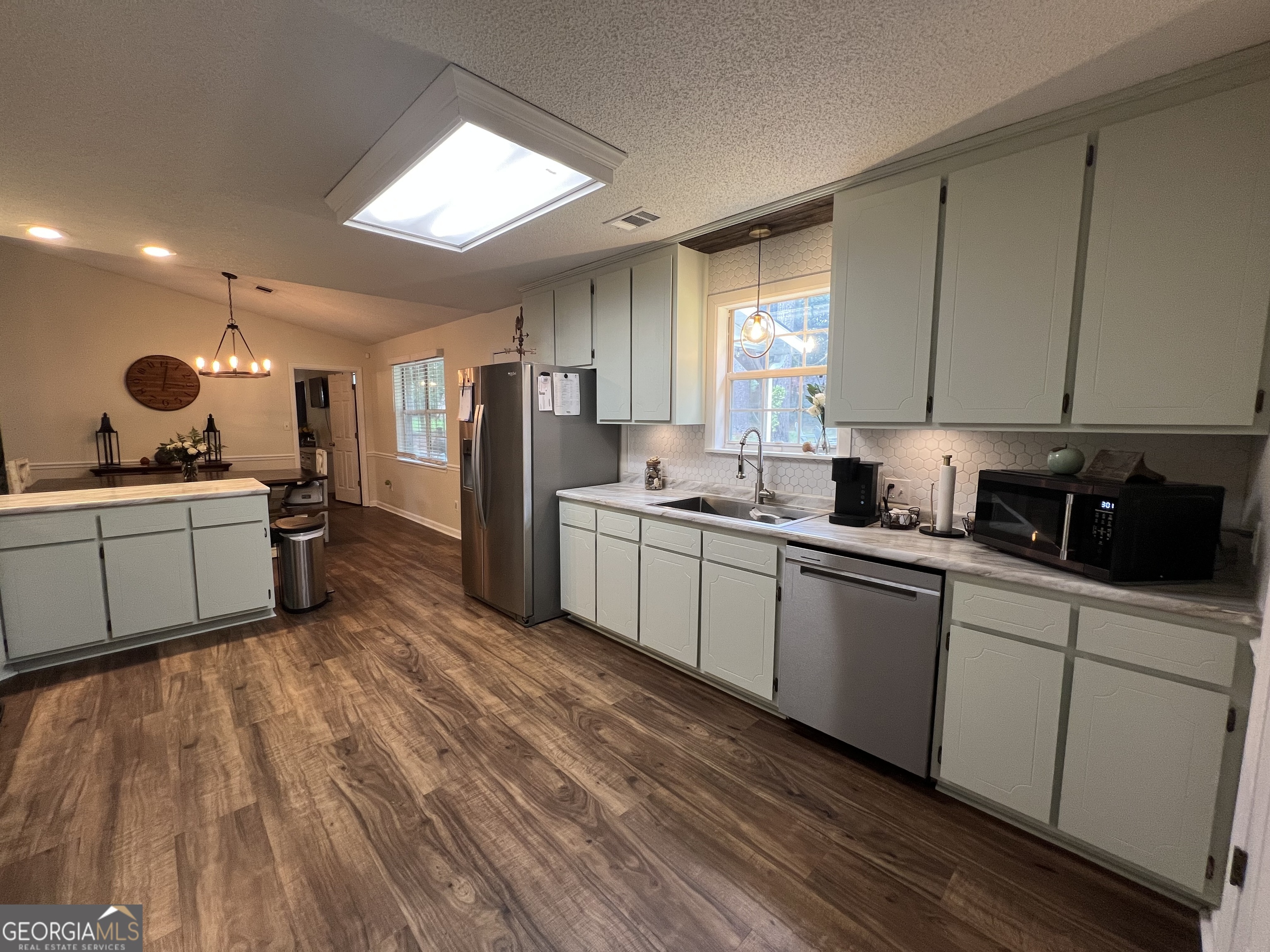 113 Camelot Drive Dublin, GA 31021 - Photo 21 of 45 a kitchen with a sink stainless steel appliances and cabinets