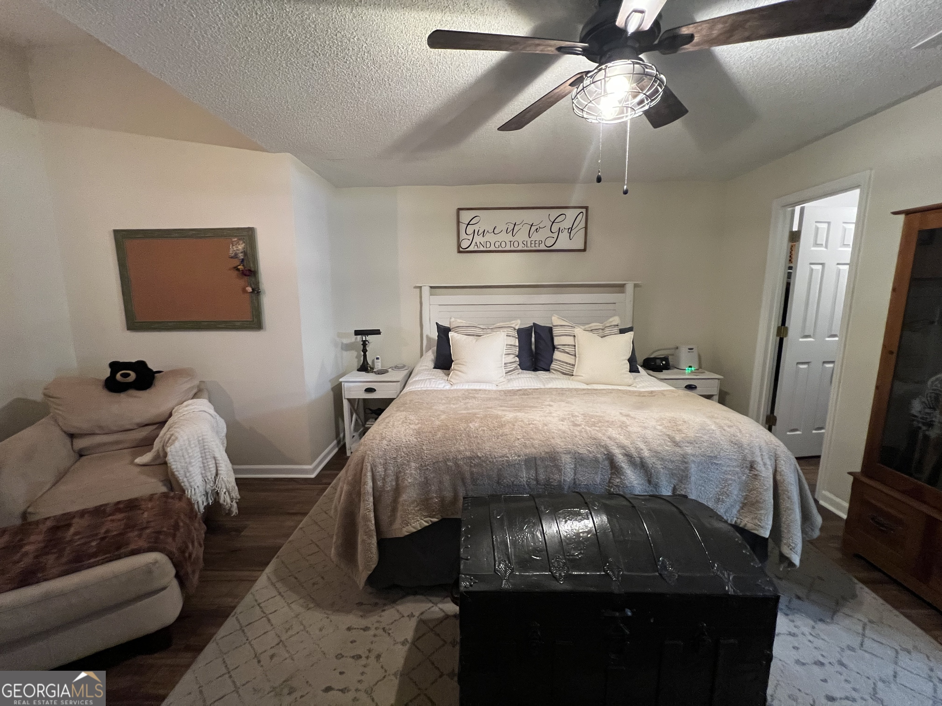 113 Camelot Drive Dublin, GA 31021 - Photo 28 of 45 a bedroom with a bed and a chandelier