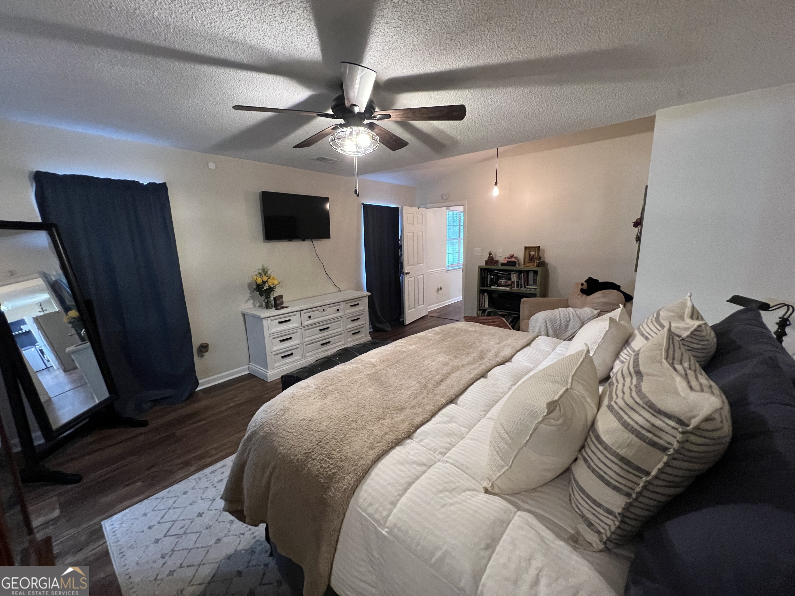 113 Camelot Drive Dublin, GA 31021 - Photo 29 of 45 a bed room with a bed a television and a dresser
