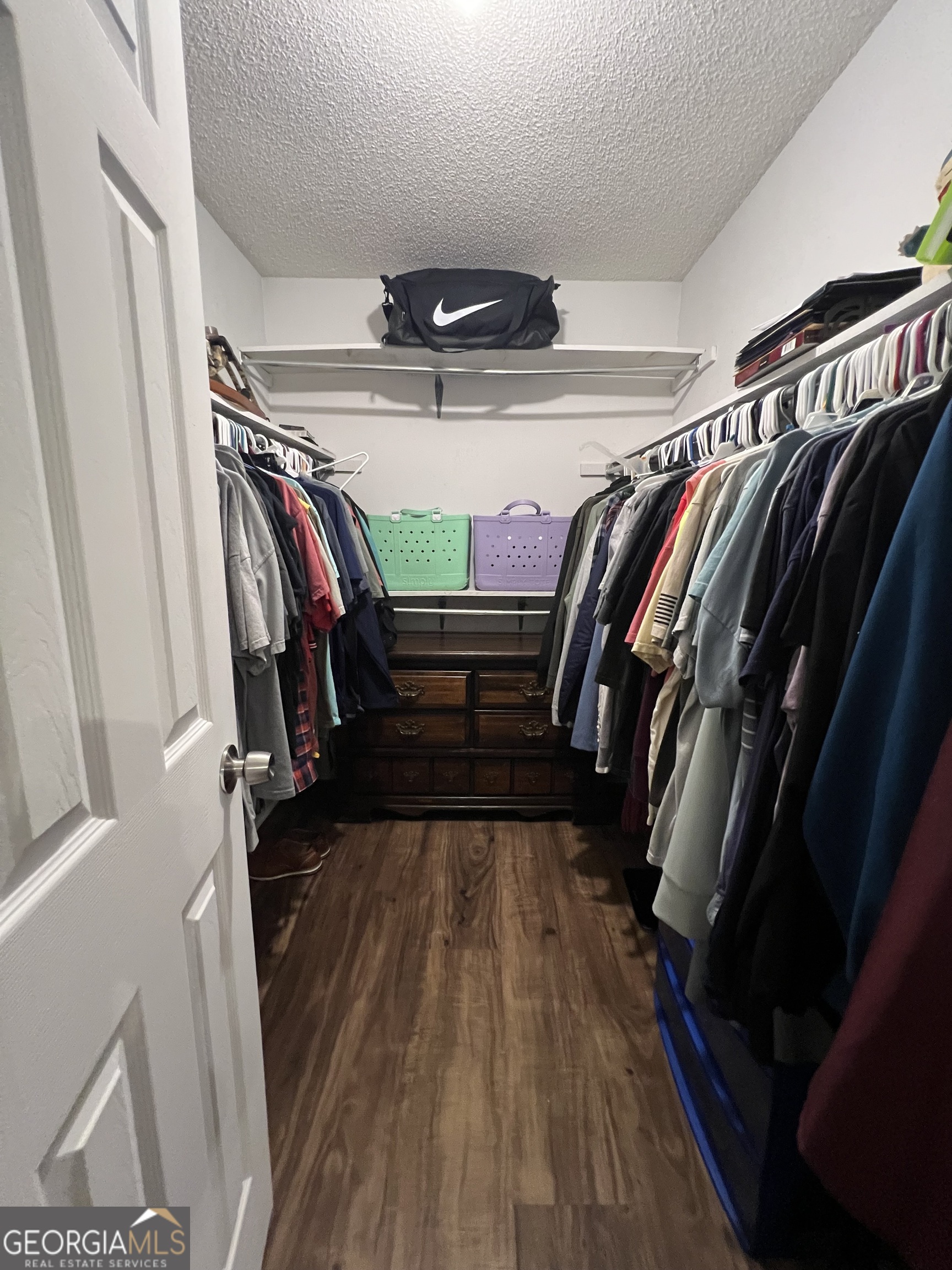 113 Camelot Drive Dublin, GA 31021 - Photo 30 of 45 a view of walk in closet with clothes and shoes