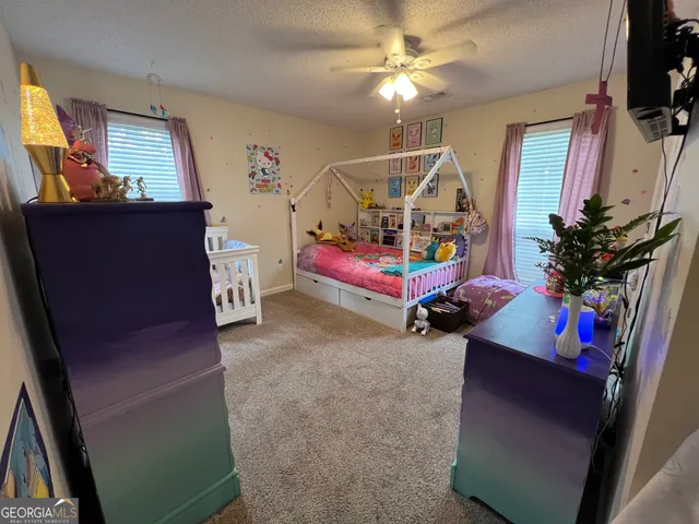 a garage with furniture and a flat screen tv