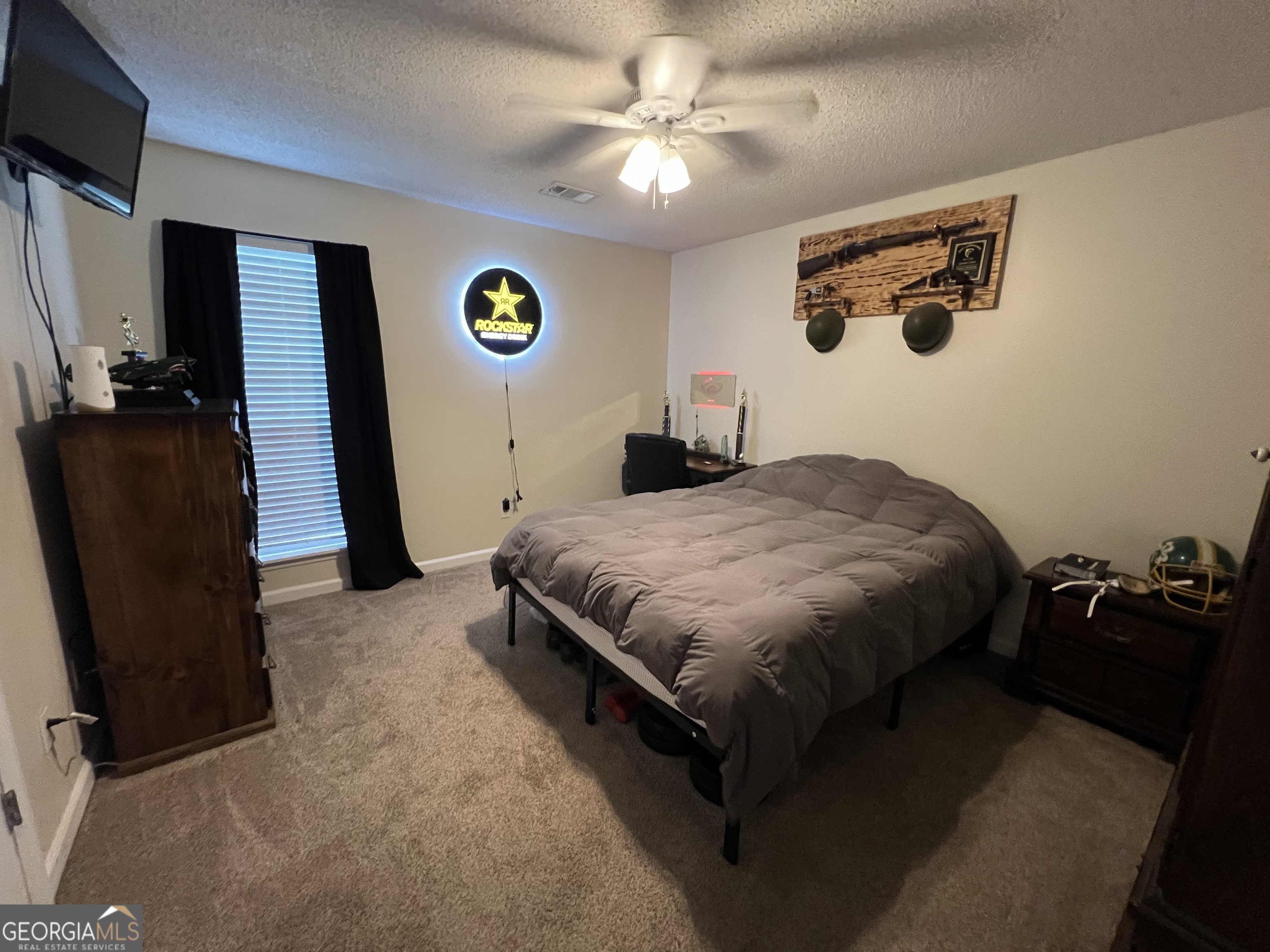 113 Camelot Drive Dublin, GA 31021 - Photo 40 of 45 a bedroom with a bed and a flat screen tv