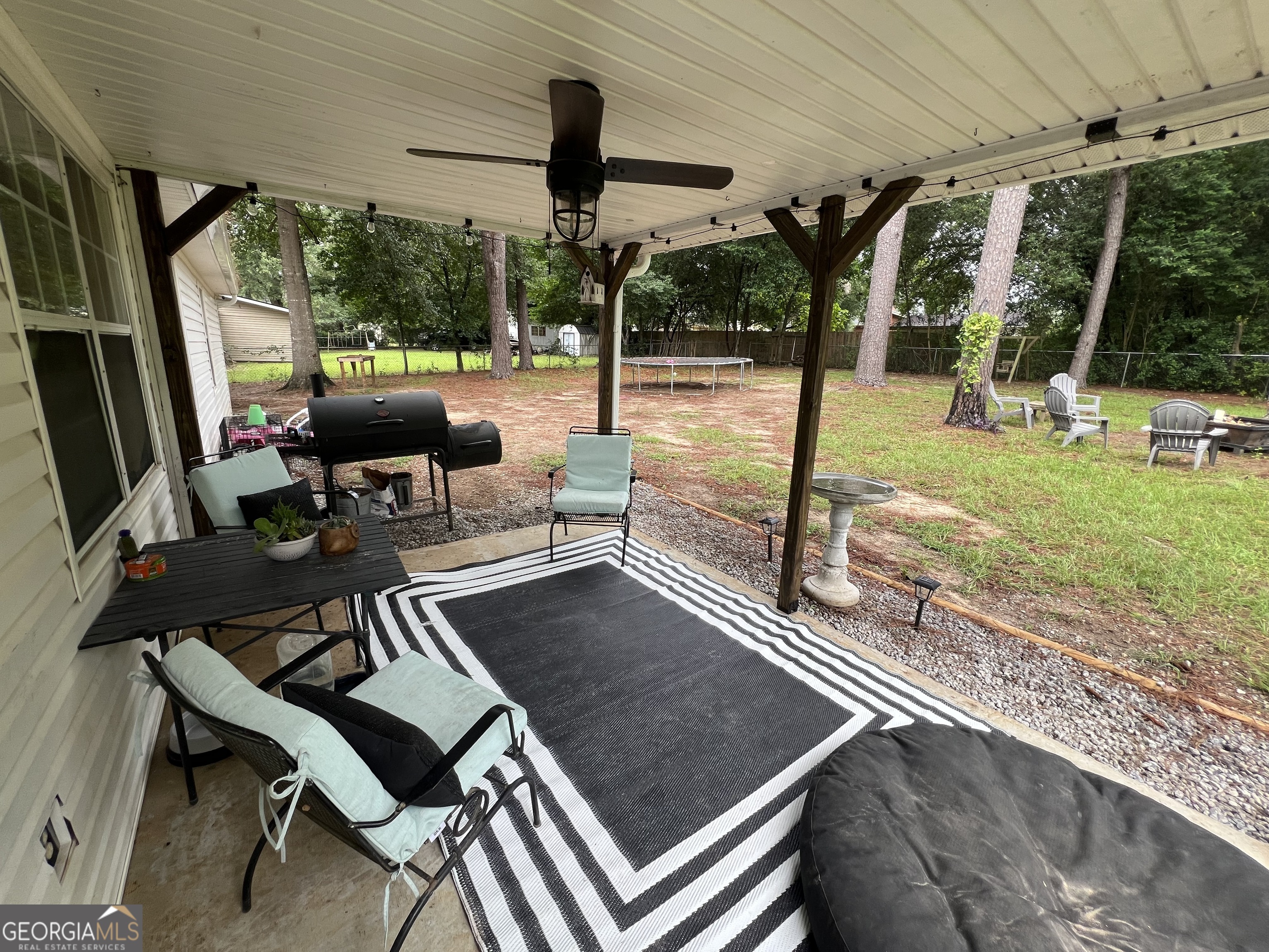 113 Camelot Drive Dublin, GA 31021 - Photo 42 of 45 a view of a patio with a table chairs and a backyard