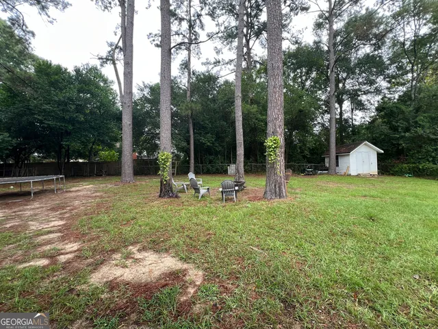 a view of a house with backyard porch and sitting area