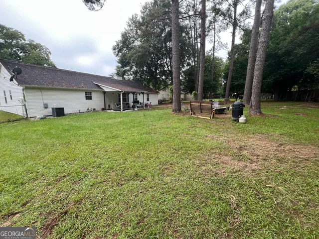 a view of a park with large trees