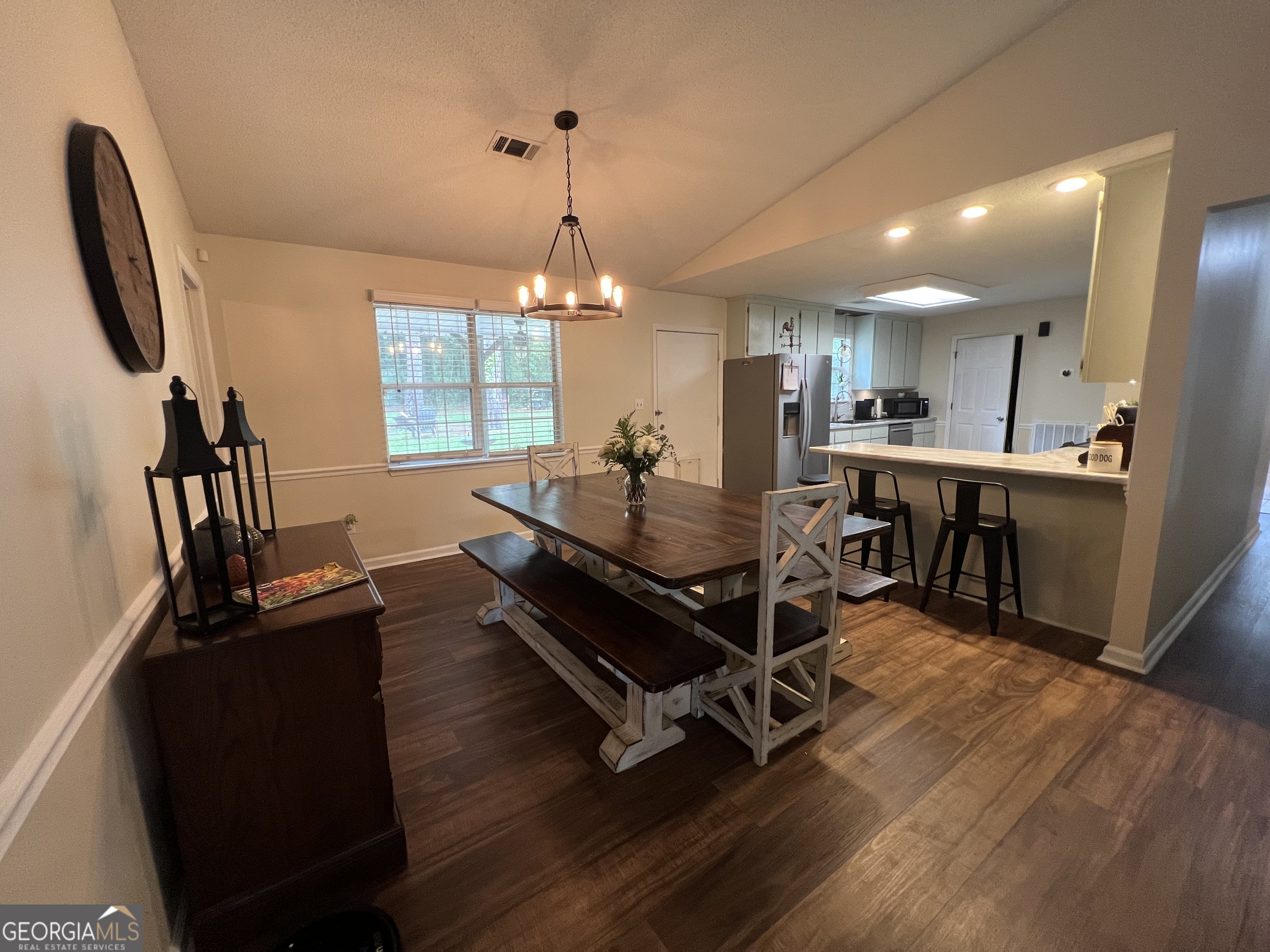 113 Camelot Drive Dublin, GA 31021 - Photo 6 of 45 a living room with a table chairs and a wooden floor