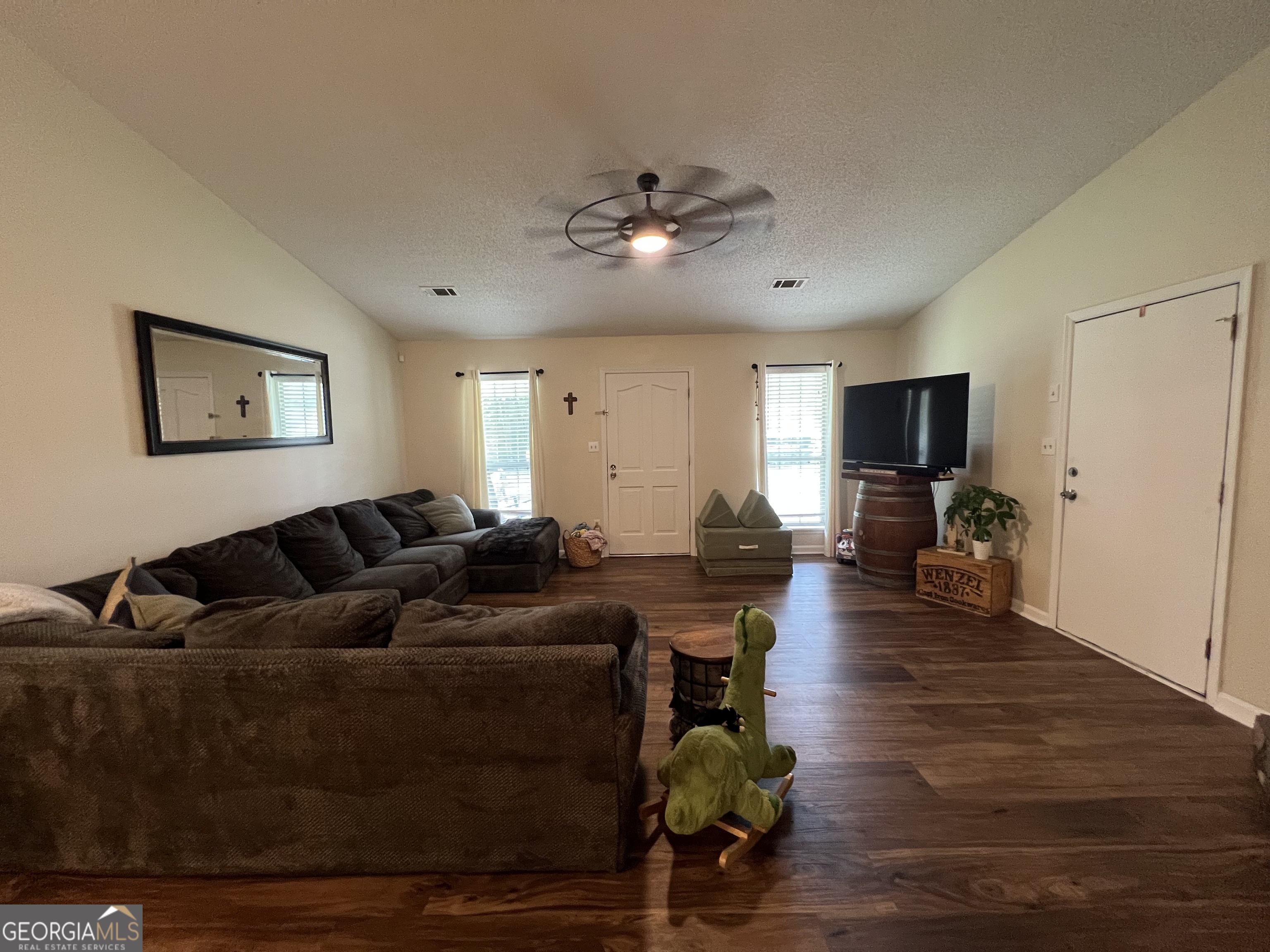 113 Camelot Drive Dublin, GA 31021 - Photo 7 of 45 a living room with furniture and a wooden floor