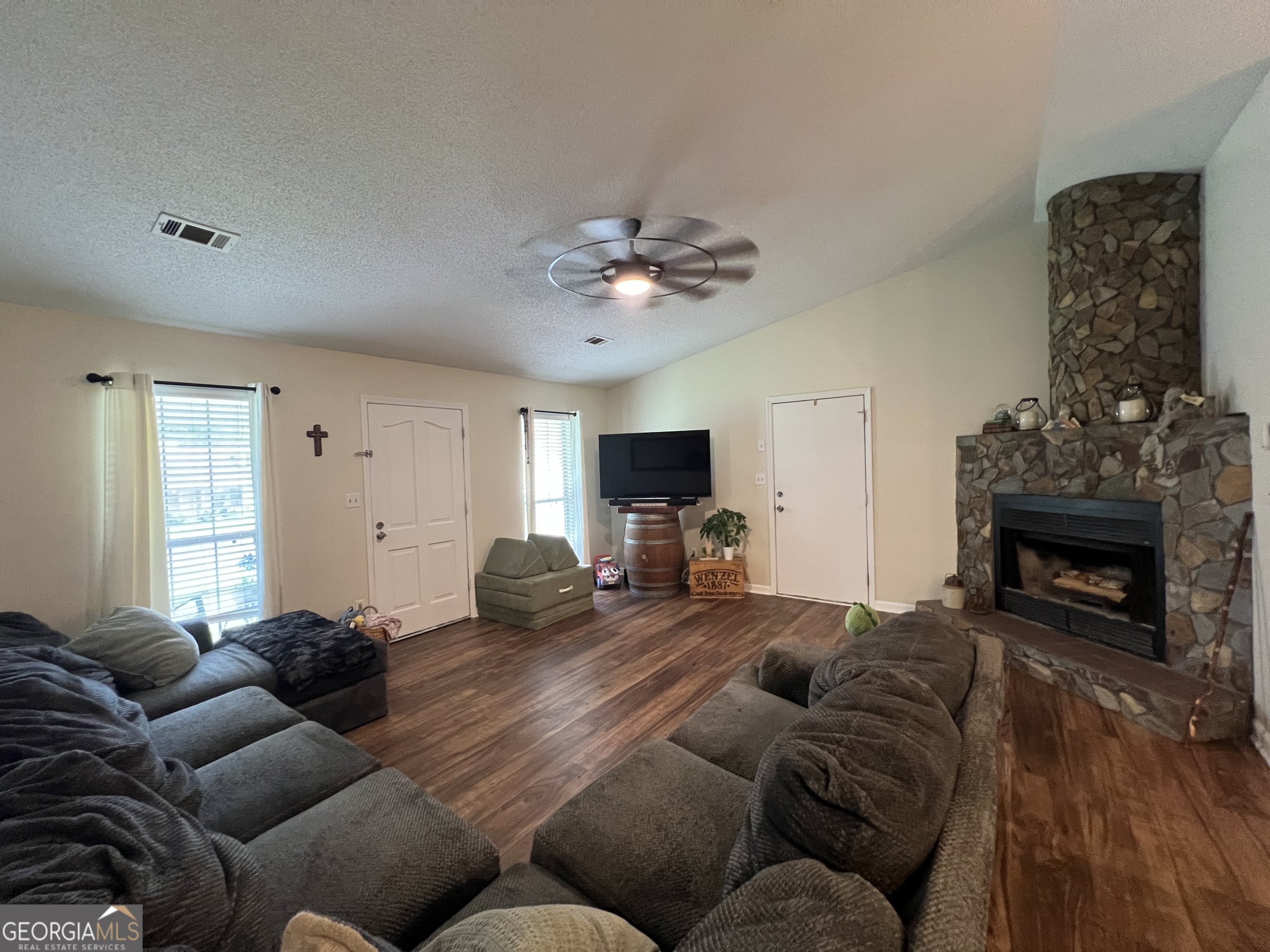 113 Camelot Drive Dublin, GA 31021 - Photo 8 of 45 a living room with furniture a fireplace and a flat screen tv