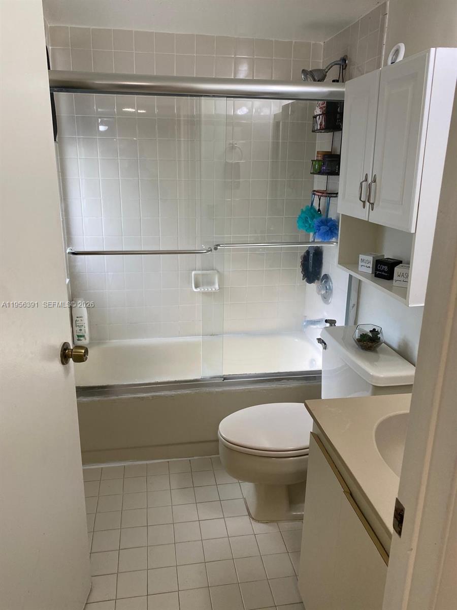 9070 Southwest 125th Avenue, Unit A101 Miami, FL 33186 - Photo 13 of 28 a bathroom with a sink a toilet and shower