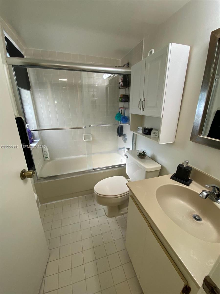 9070 Southwest 125th Avenue, Unit A101 Miami, FL 33186 - Photo 15 of 28 a bathroom with a sink a toilet and a shower