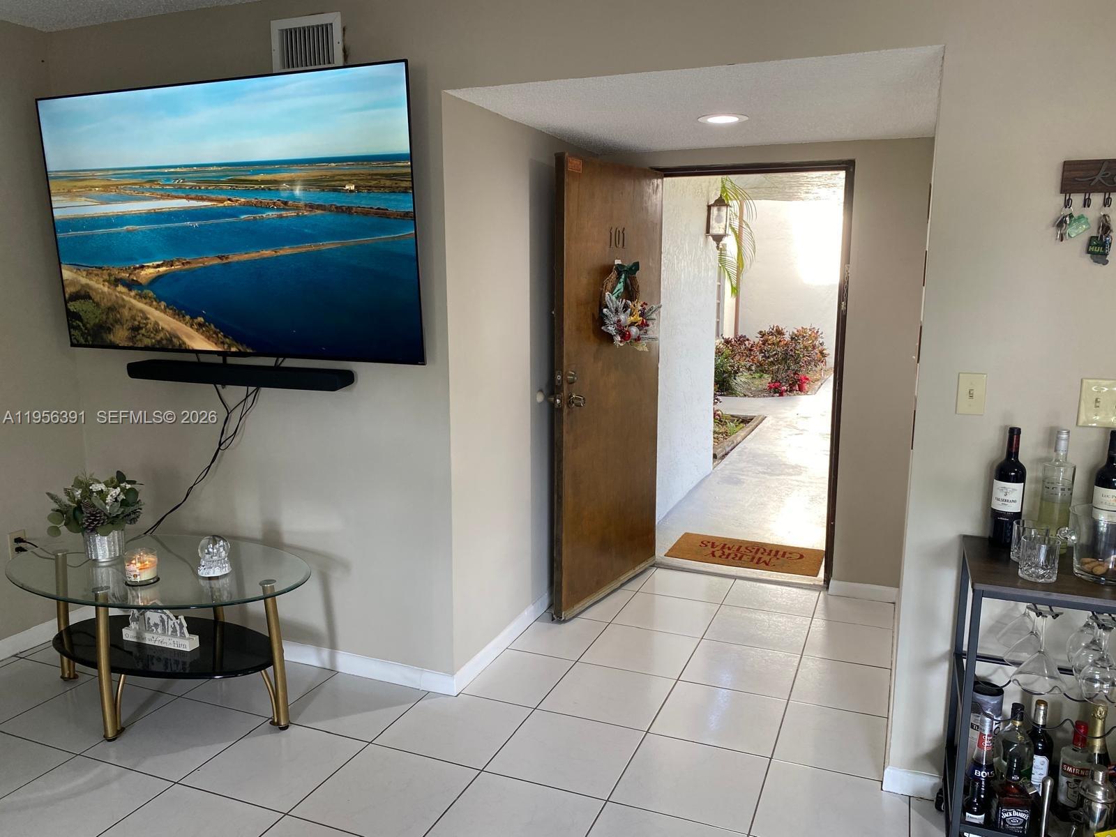 9070 Southwest 125th Avenue, Unit A101 Miami, FL 33186 - Photo 10 of 28 a view of a hallway to room and dining room