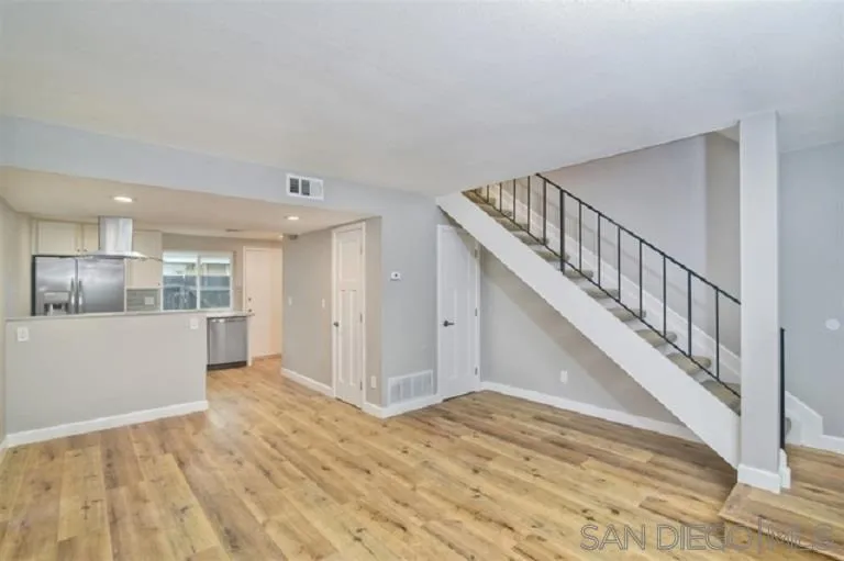 2520 Wanek Road, Unit B Escondido, CA 92027 - Photo 4 of 12 a view of staircase and kitchen with wooden floor