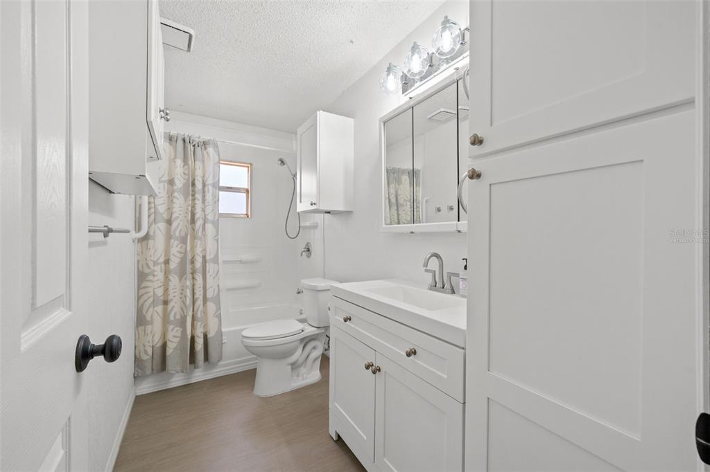4489 Fishman Avenue Weeki Wachee, FL 34607 - Photo 12 of 29 a bathroom with a double vanity sink toilet and shower