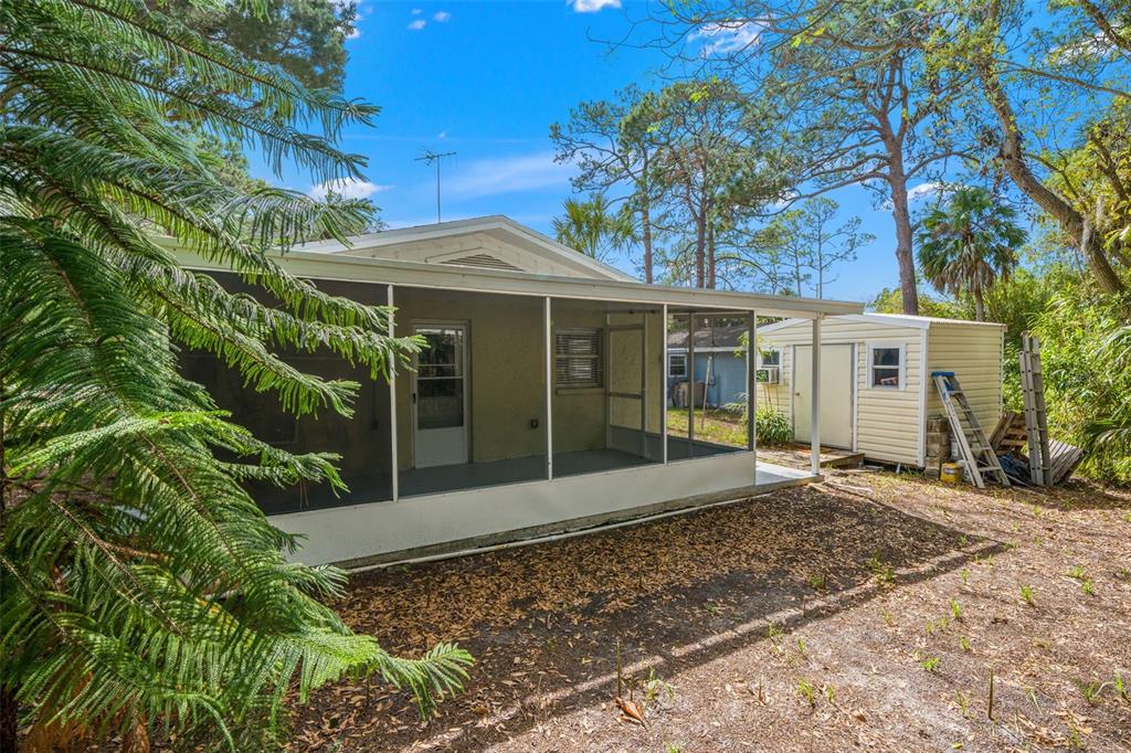 4489 Fishman Avenue Weeki Wachee, FL 34607 - Photo 16 of 29 a front view of a house with a garden